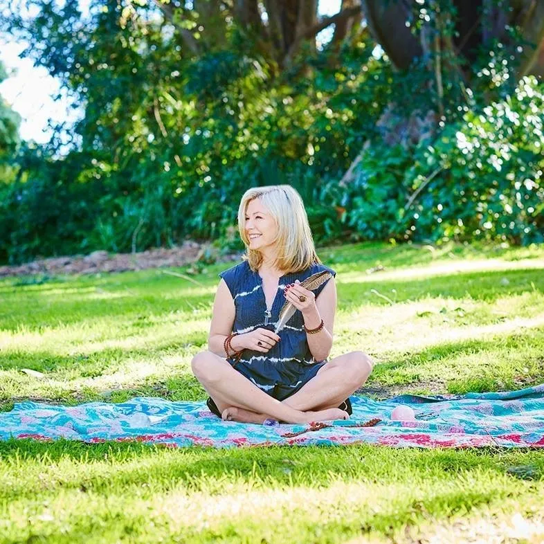 Melinda meditating in a beautiful garden